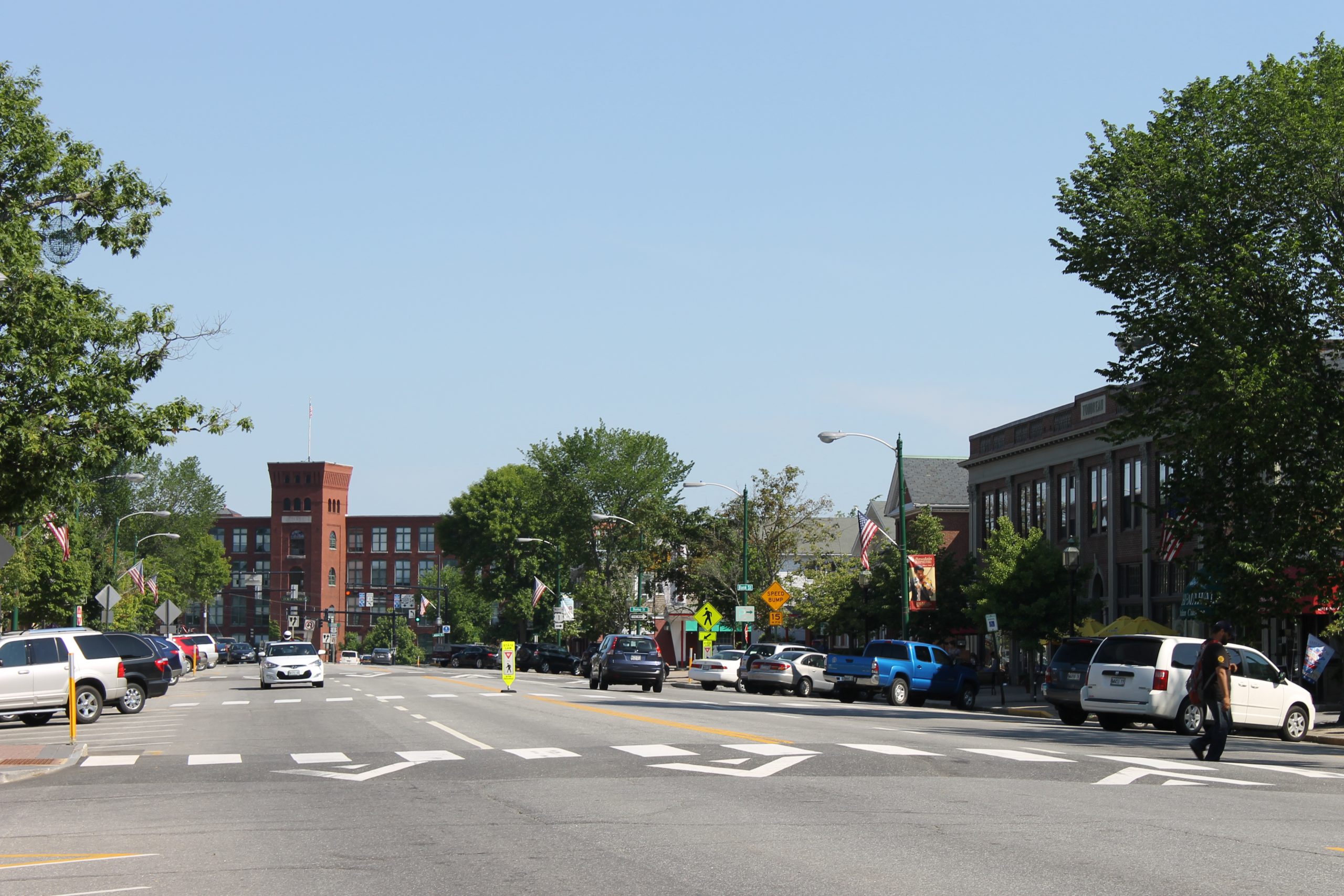 Downtown Brunswick Maine showing Main Street, shops, and historic brick buildings.
