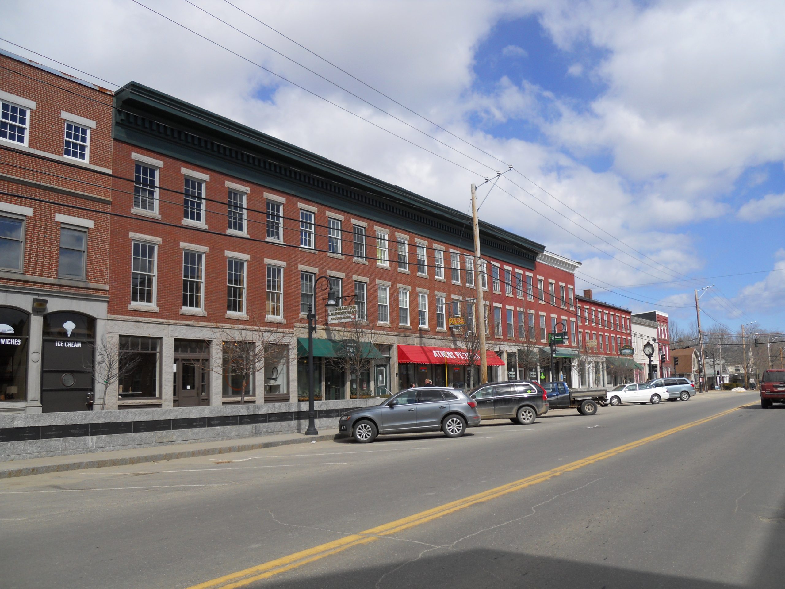 Downtown Thomaston Maine showing historic brick buildings and local shops along Main Street.