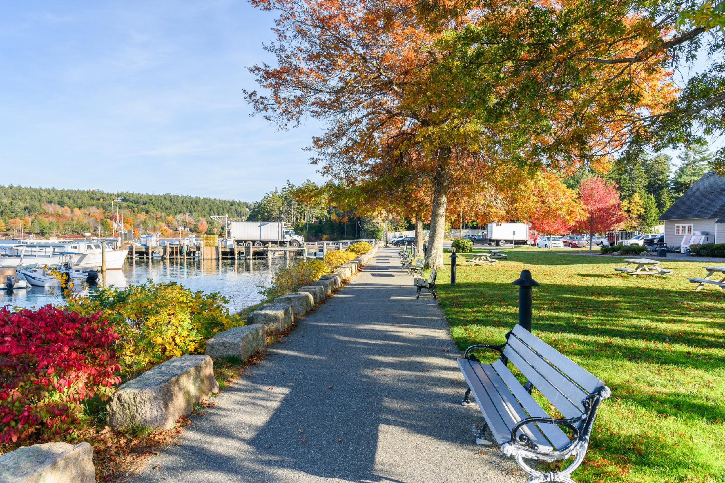 Scenic waterfront walkway with benches along the Belfast Maine harbor
