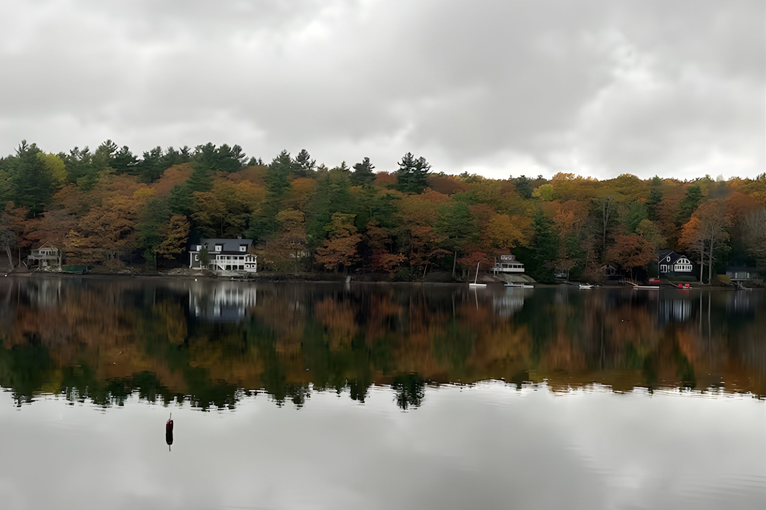 Norton Pond in Lincolnville Maine with waterfront homes and fall foliage reflections