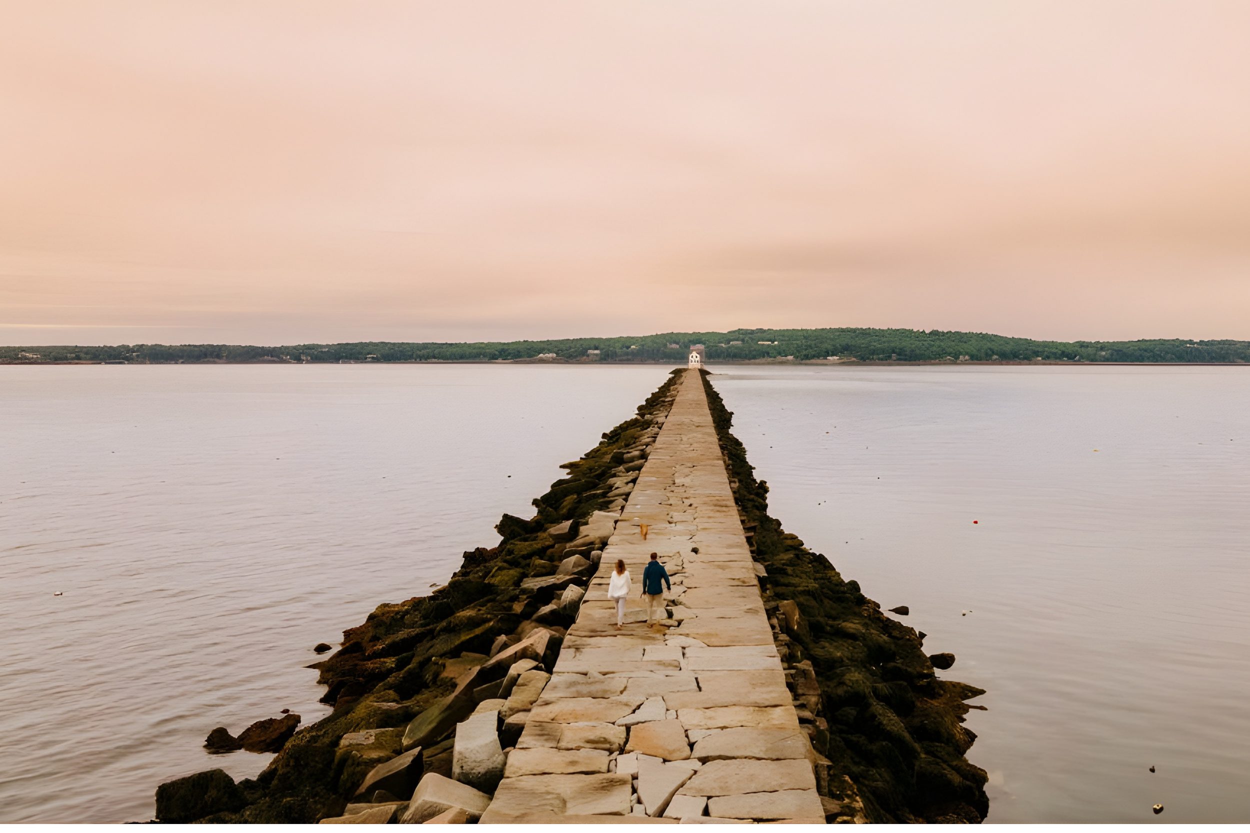 Rockland Breakwater in Maine with long stone walkway leading to lighthouse