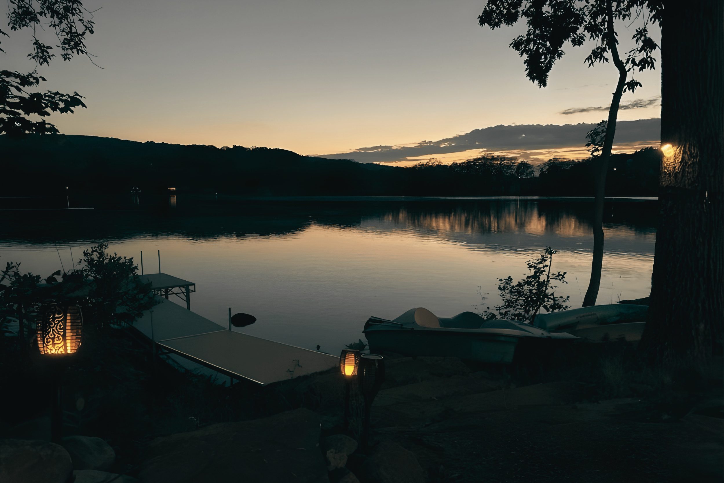 Quiet lake at dusk with private dock and soft lighting in Union Maine