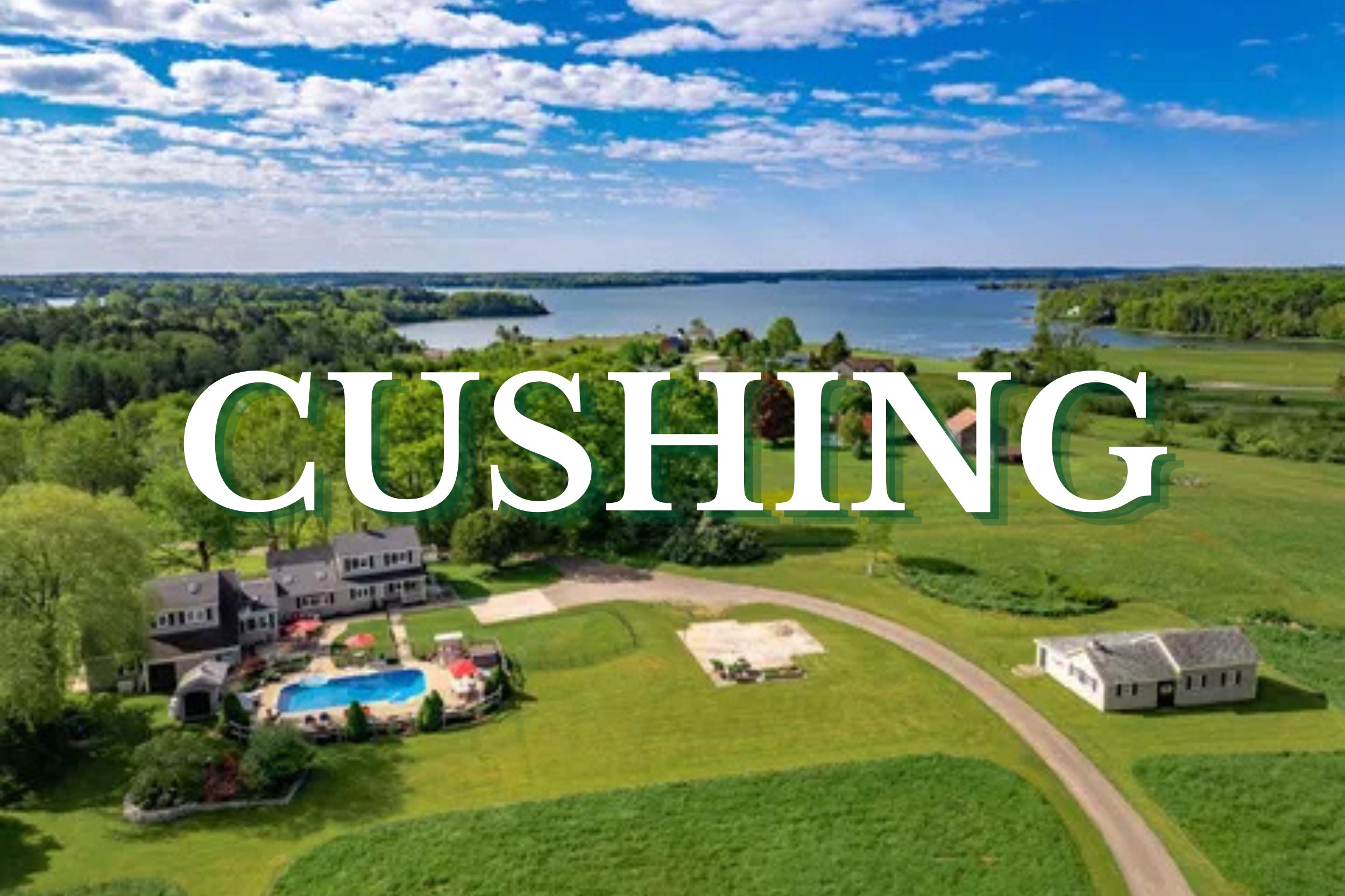Aerial view of waterfront countryside estate and open green fields in Cushing, Maine