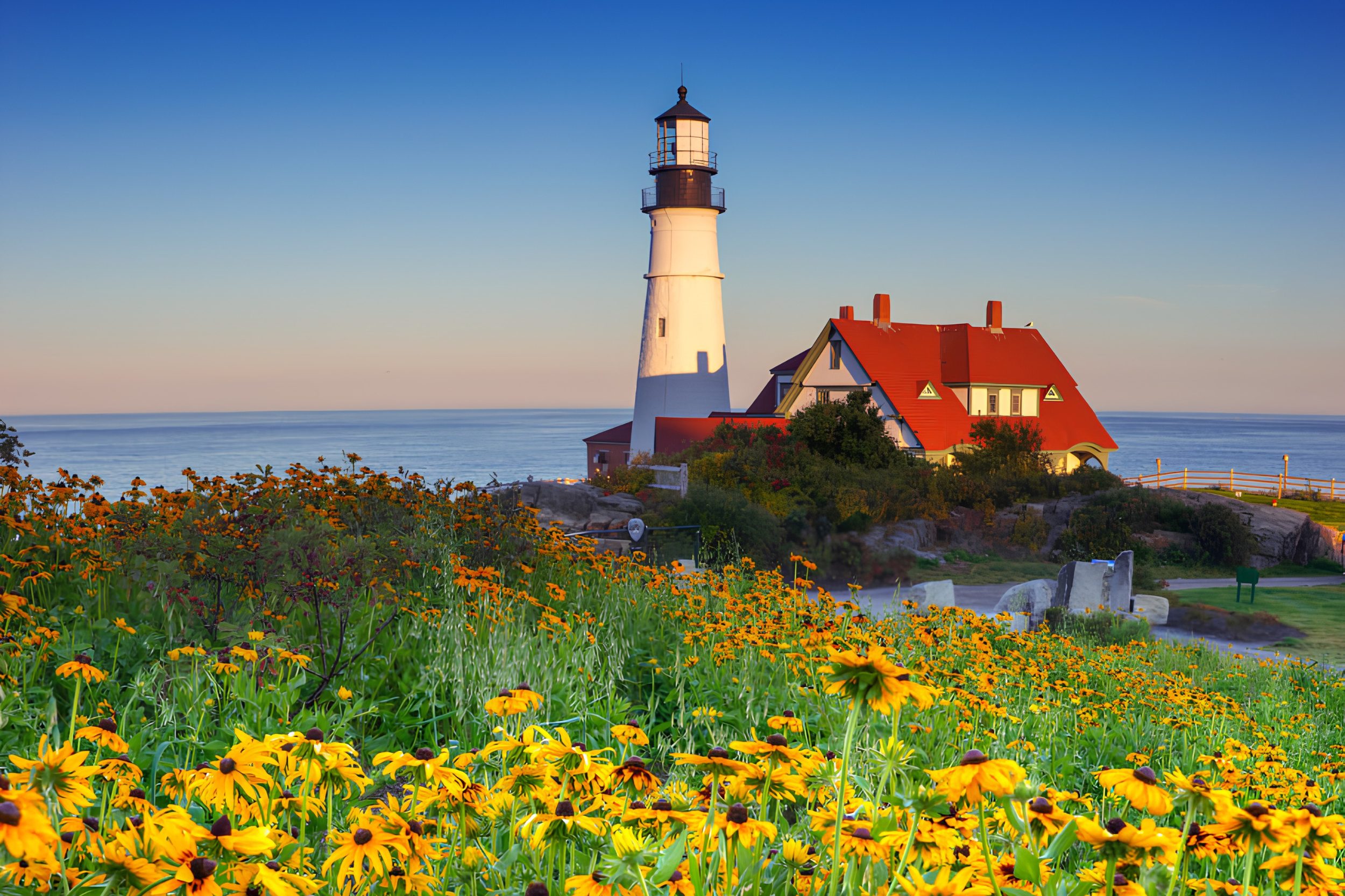 Portland Head Light lighthouse with wildflowers overlooking the Maine coast