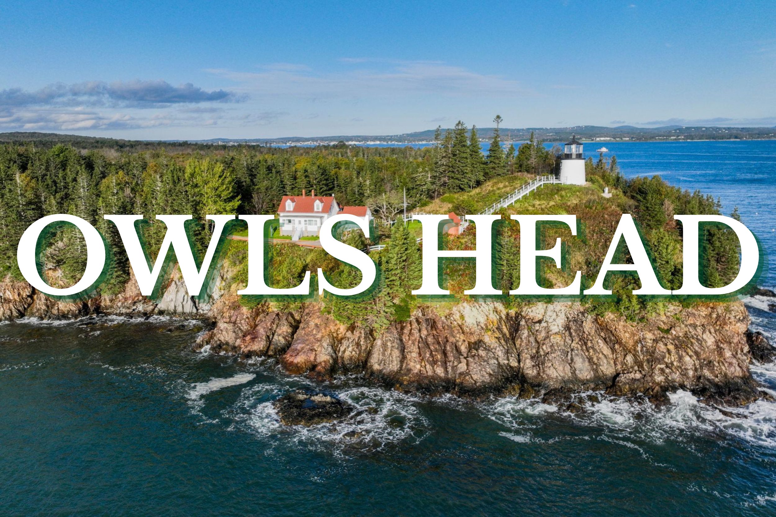 Aerial view of Owls Head Lighthouse on rocky cliffs overlooking the Atlantic Ocean in Maine