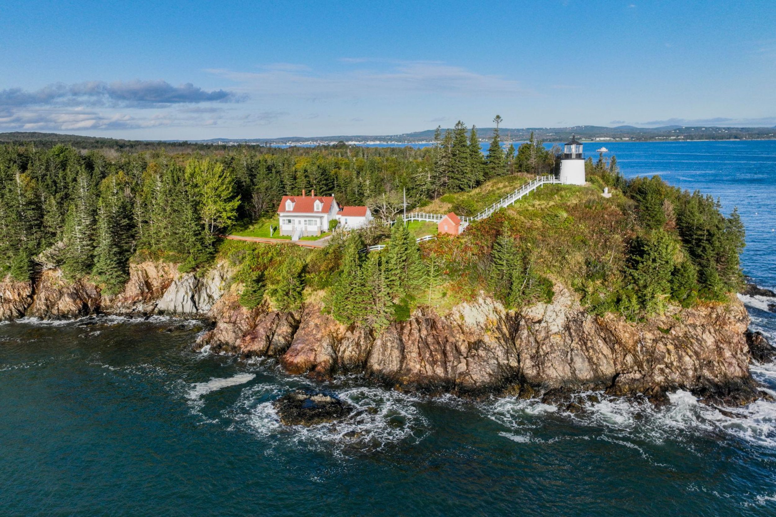 Aerial view of Owls Head Light on the rocky coastline of Owls Head Maine