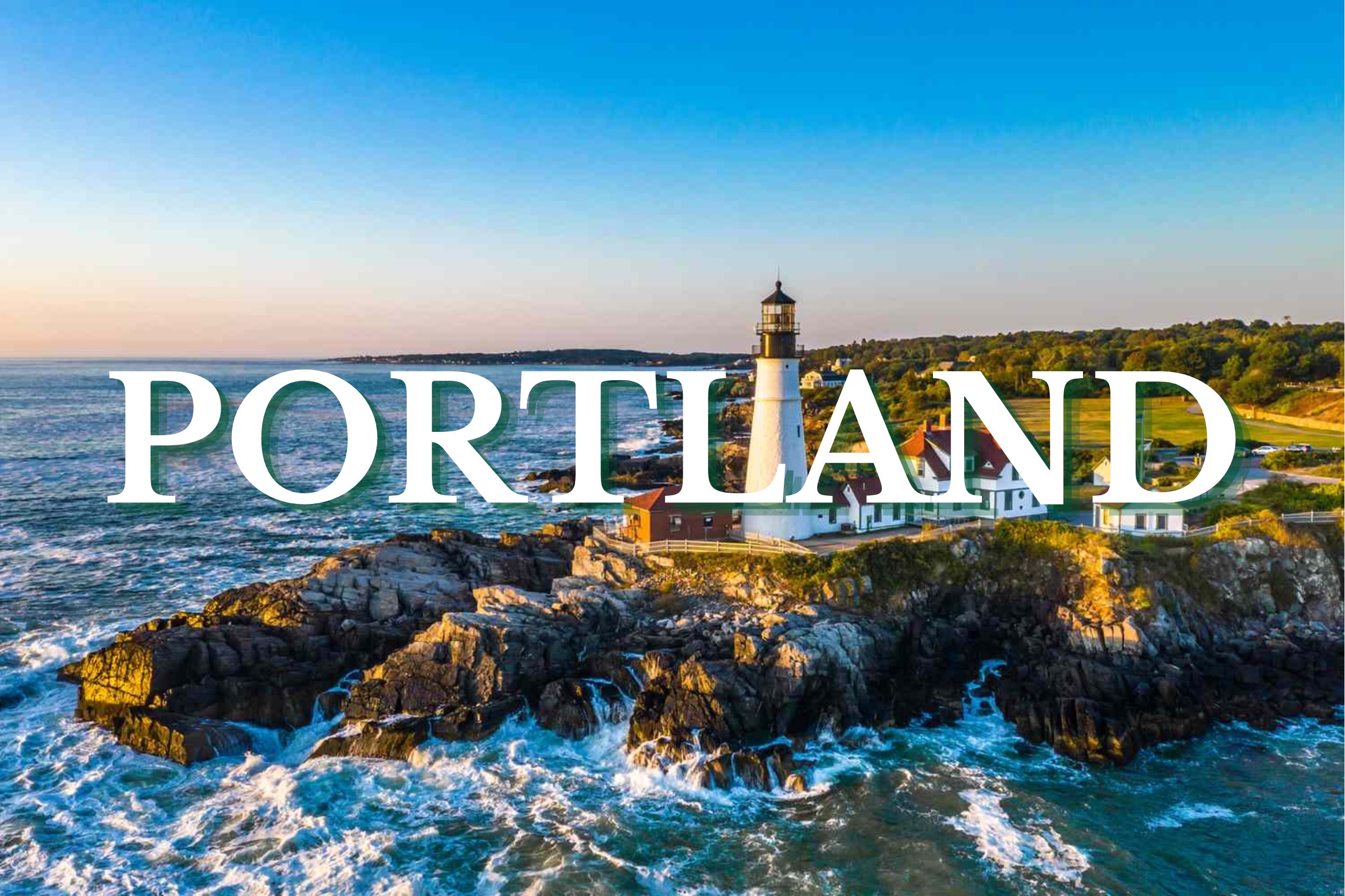 Aerial view of Portland Head Light lighthouse on rocky ocean cliffs in Portland, Maine