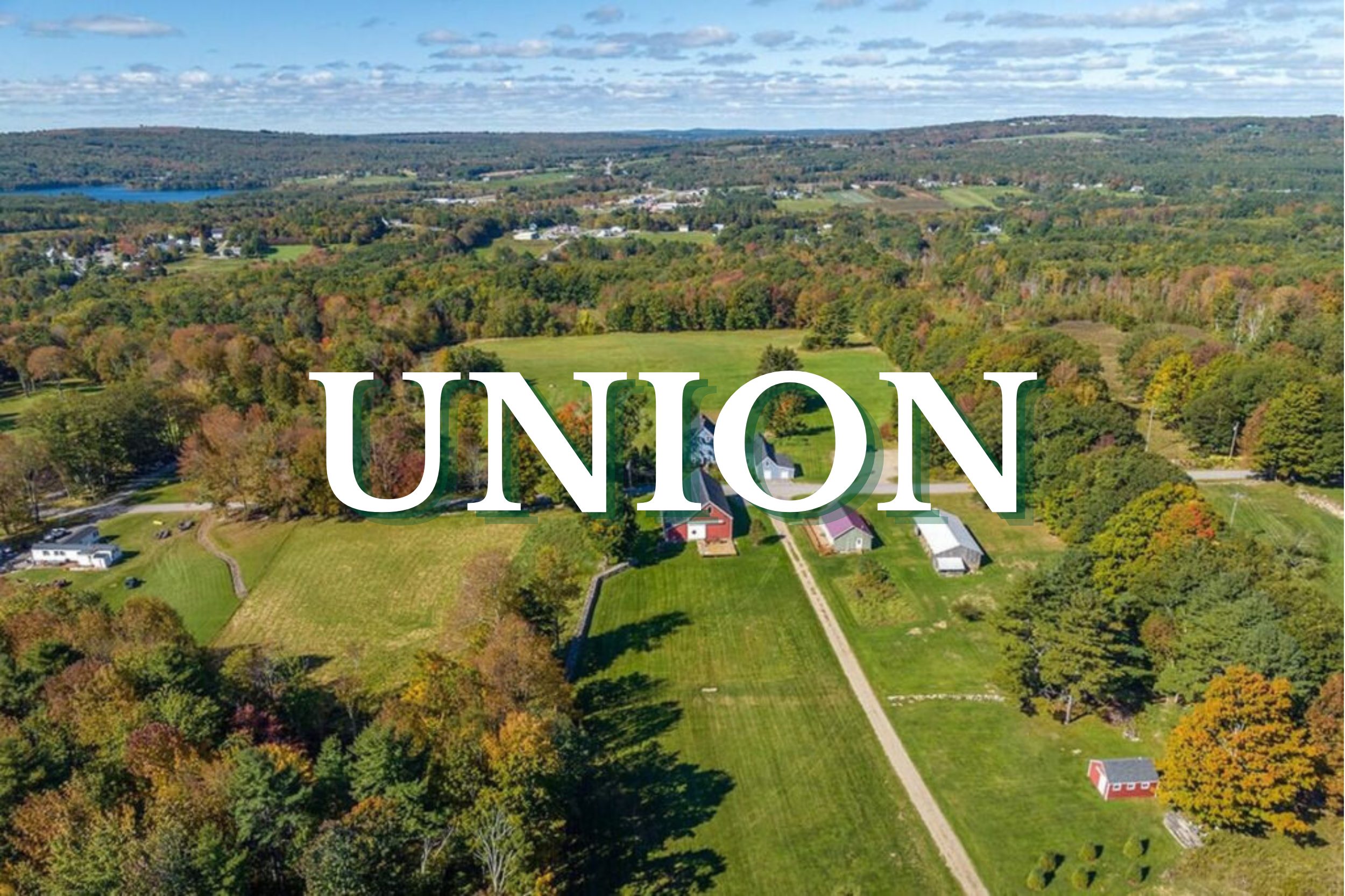 Aerial view of farmland, homes, and rolling hills in Union, Maine during autumn