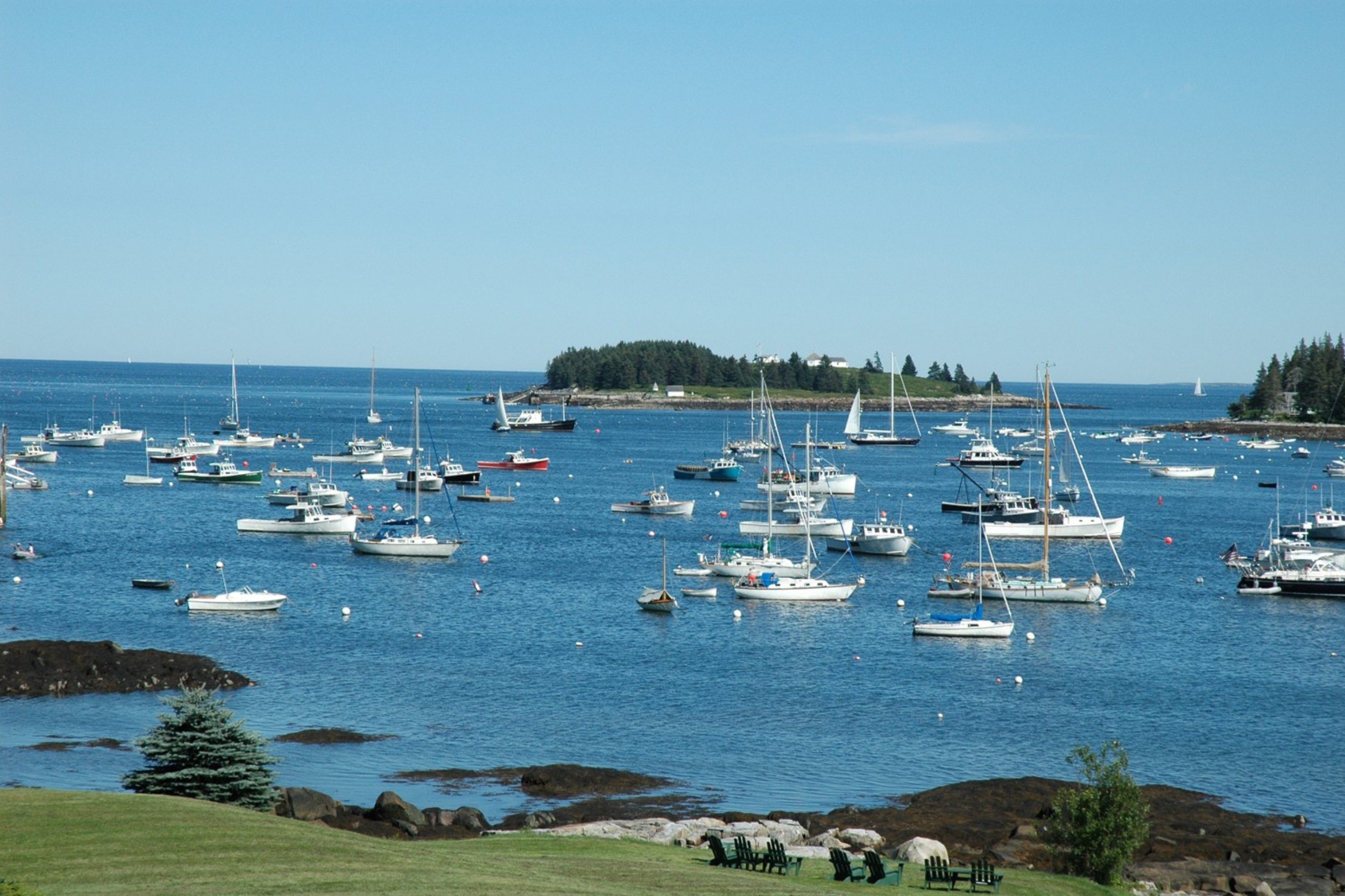 Boats anchored in Tenants Harbor in St. George Maine on a clear summer day