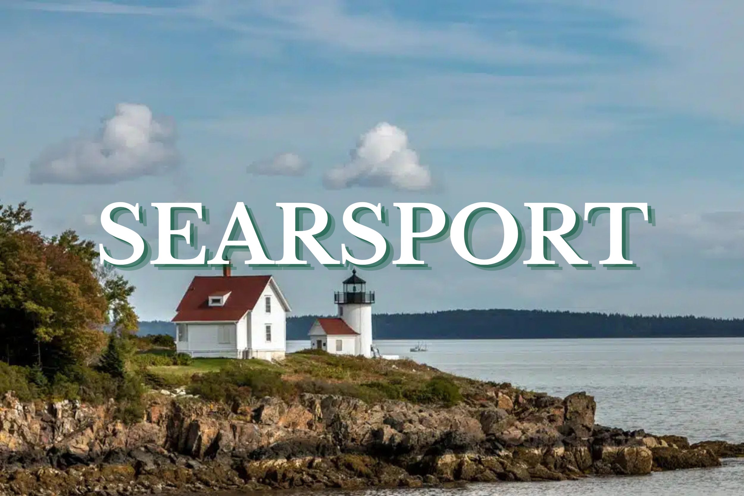 Lighthouse overlooking rocky shoreline and calm ocean waters in Searsport, Maine