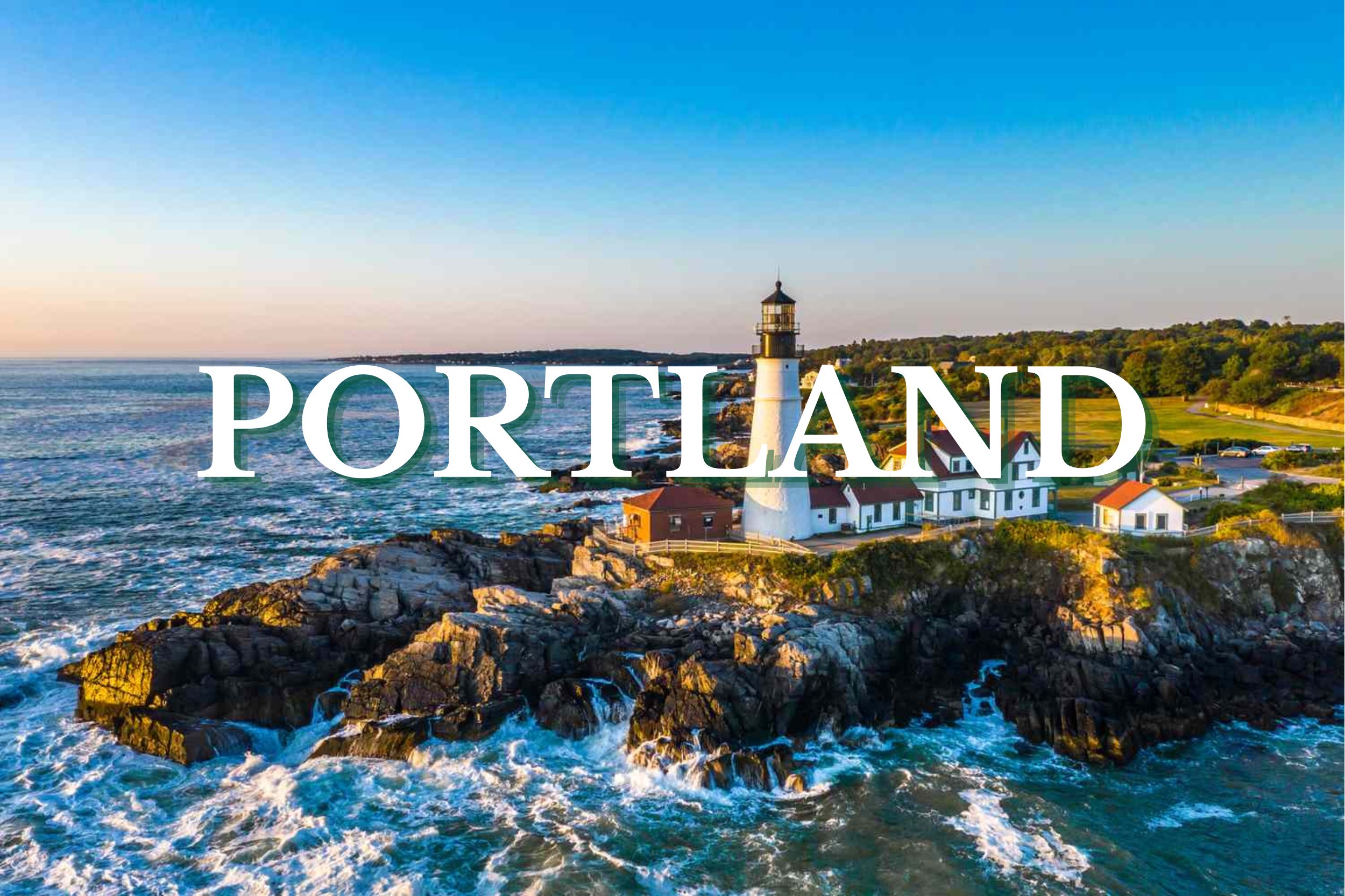 Aerial view of Portland Head Light surrounded by rocky coastline and ocean waves in Portland, Maine