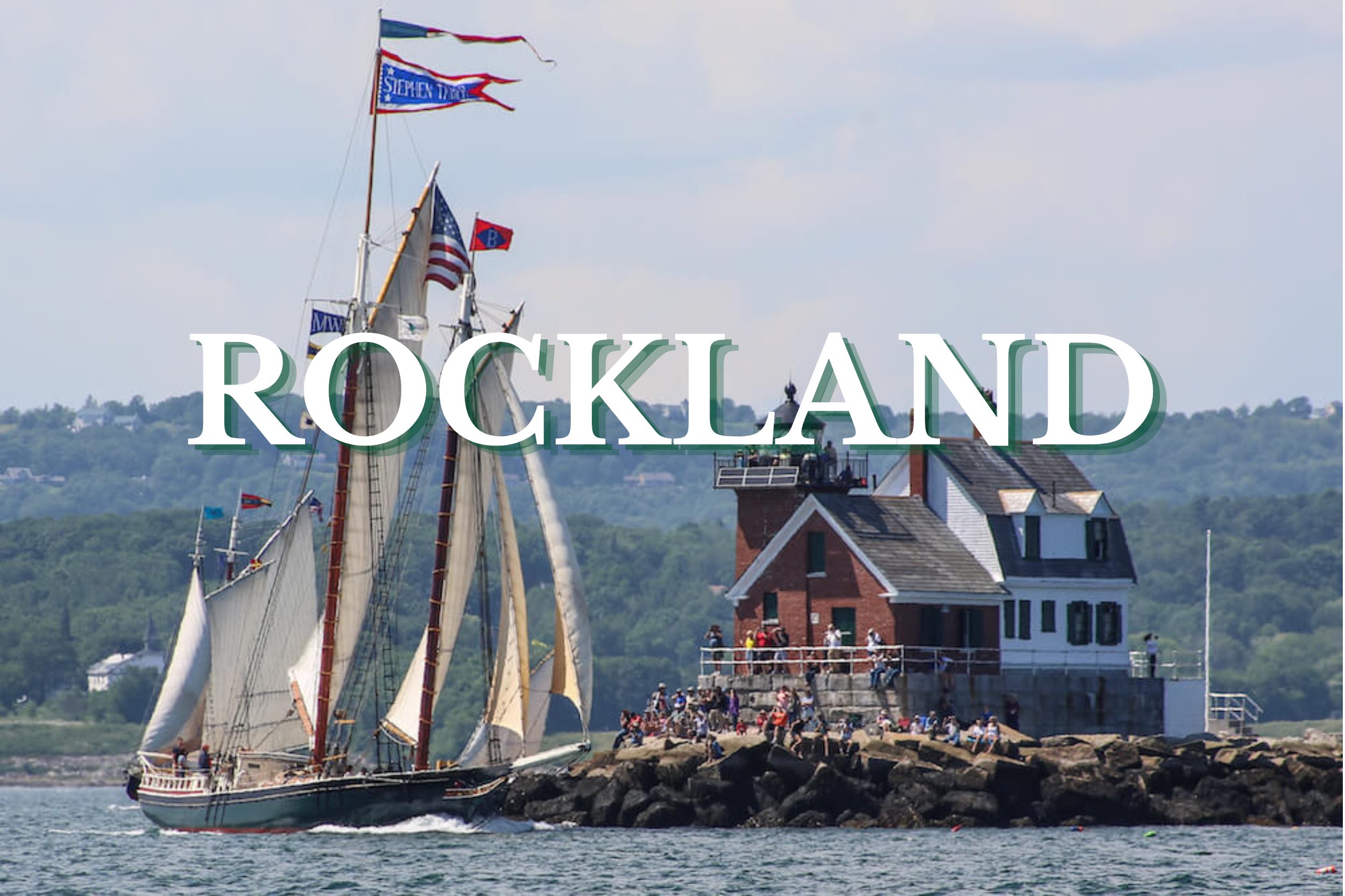 Tall sailing ship approaching the Rockland Breakwater Lighthouse on the coast of Rockland, Maine