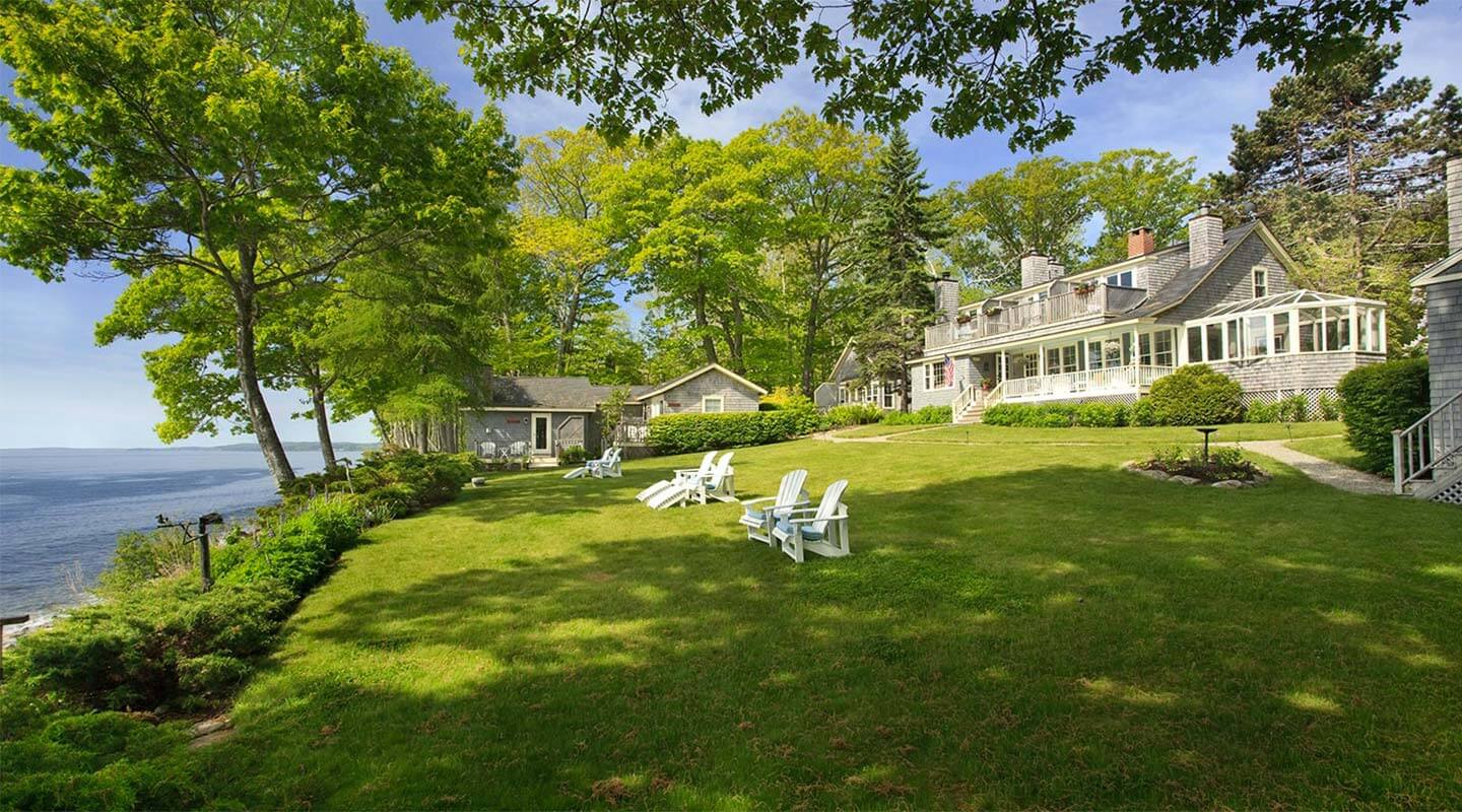 Luxury waterfront estate with expansive lawn, guest cottage, and ocean views in Midcoast Maine